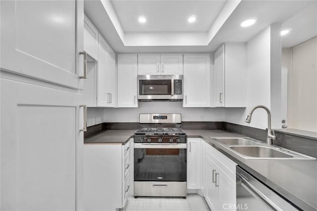 600 W 3rd St Unit C207, Santa Ana, CA 92701 - kitchen featuring stainless steel appliances, white cabinetry, recessed lighting, a raised ceiling, and dark countertops