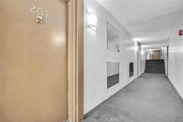 600 W 3rd St Unit C207, Santa Ana, CA 92701 - hallway with a textured ceiling, carpet, and stairs