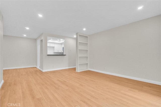 600 W 3rd St Unit C207, Santa Ana, CA 92701 - unfurnished living room featuring light wood-style floors and recessed lighting