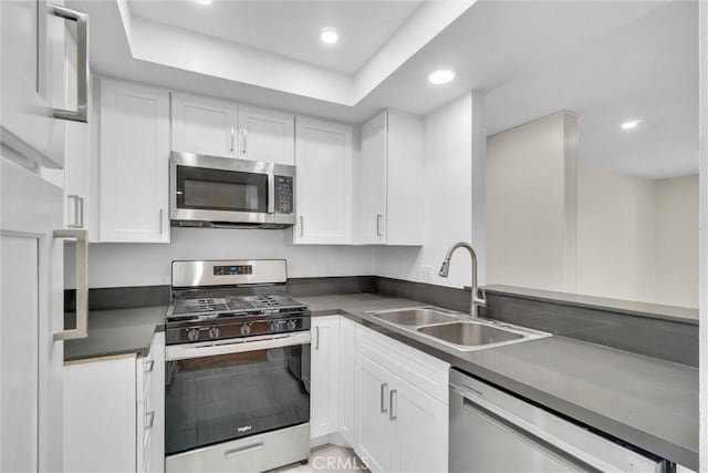 600 W 3rd St Unit C207, Santa Ana, CA 92701 - kitchen featuring appliances with stainless steel finishes, dark countertops, recessed lighting, and white cabinets