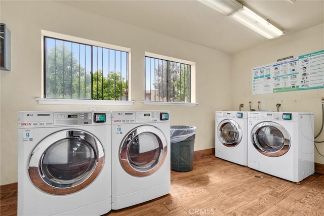 600 W 3rd St Unit C207, Santa Ana, CA 92701 - communal laundry room featuring washing machine and clothes dryer, plenty of natural light, and wood finished floors
