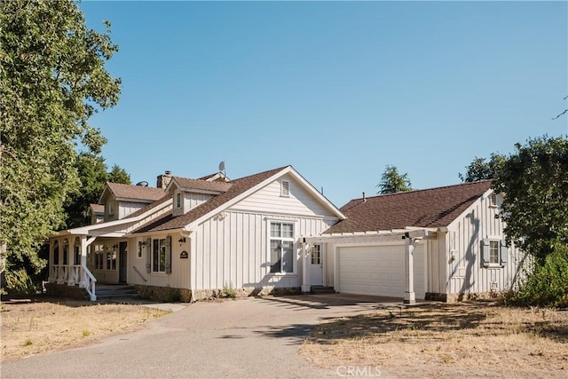 40 Bobcat Springs Rd, Buellton, CA 93427 - view of front of property with driveway, an attached garage, covered porch, board and batten siding, and a chimney