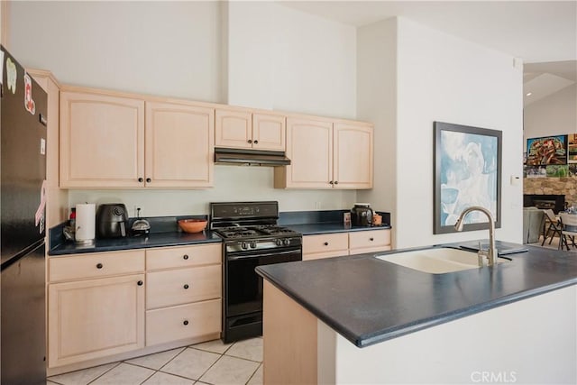 40 Bobcat Springs Rd, Buellton, CA 93427 - kitchen with black gas range, light brown cabinetry, under cabinet range hood, dark countertops, and a towering ceiling