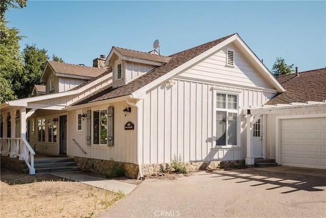 40 Bobcat Springs Rd, Buellton, CA 93427 - view of front of house featuring a chimney, a garage, driveway, covered porch, and a shingled roof
