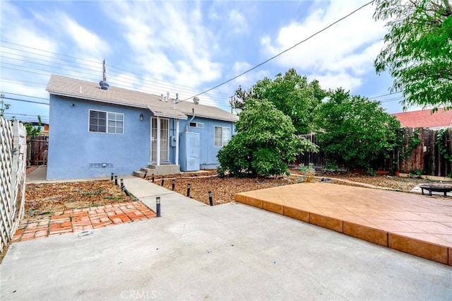 13018 Rosecrans Ave, Norwalk, CA 90650 - view of front of property with stucco siding, a patio area, a fenced backyard, and entry steps