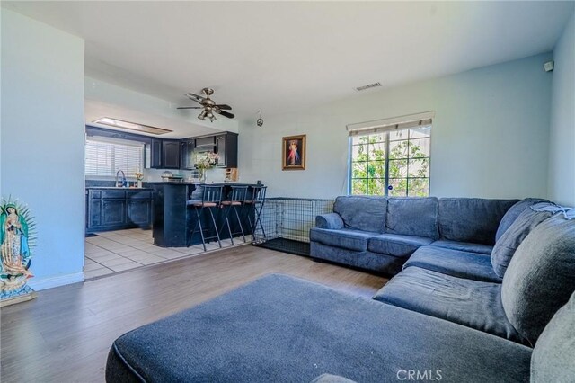 13018 Rosecrans Ave, Norwalk, CA 90650 - living room featuring light wood-style floors and ceiling fan