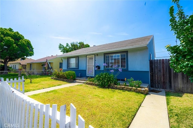 13018 Rosecrans Ave, Norwalk, CA 90650 - view of front facade with stucco siding and a fenced backyard
