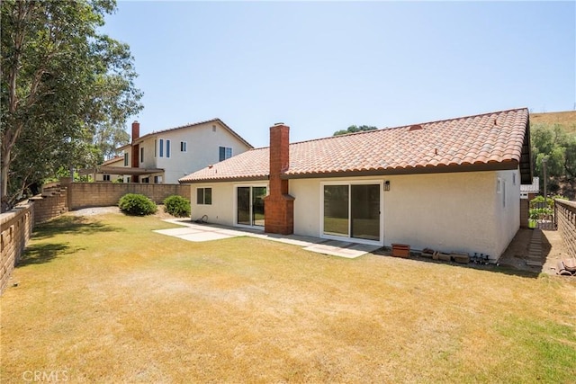 22 Sage Cyn, Pomona, CA 91766 - rear view of property with stucco siding, a fenced backyard, a tile roof, a chimney, and a patio area