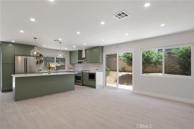 22 Sage Cyn, Pomona, CA 91766 - kitchen with high end appliances, green cabinetry, light countertops, tasteful backsplash, and light wood-style flooring