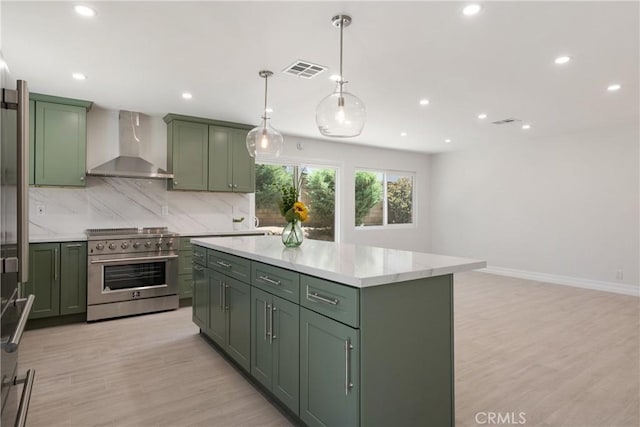 22 Sage Cyn, Pomona, CA 91766 - kitchen featuring green cabinets, high end stainless steel range oven, wall chimney range hood, decorative backsplash, and recessed lighting