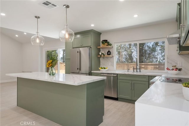 22 Sage Cyn, Pomona, CA 91766 - kitchen with green cabinetry, stainless steel appliances, tasteful backsplash, light stone countertops, and recessed lighting