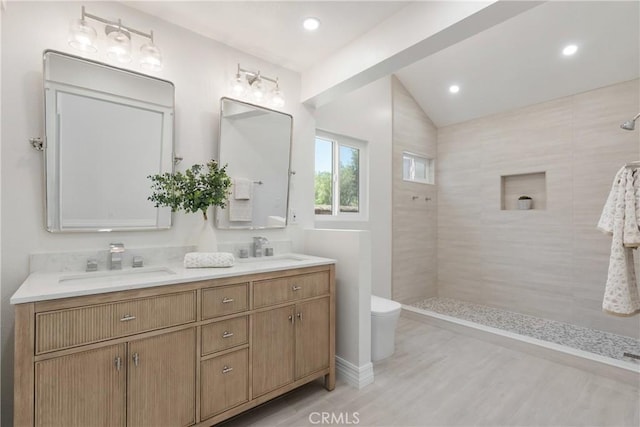 22 Sage Cyn, Pomona, CA 91766 - bathroom featuring walk in shower, double vanity, lofted ceiling, wood finished floors, and recessed lighting