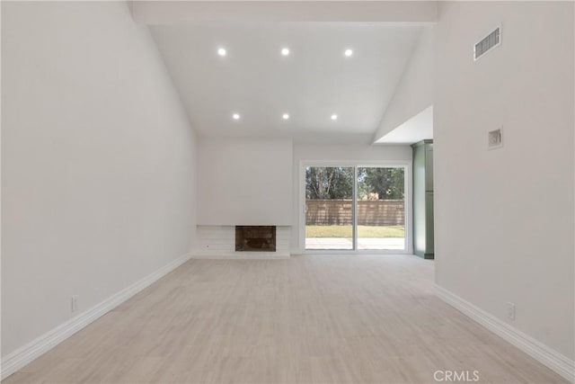 22 Sage Cyn, Pomona, CA 91766 - unfurnished living room with recessed lighting, high vaulted ceiling, a brick fireplace, and light wood finished floors
