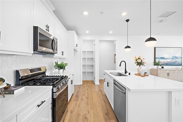 944 N Divino Privado Unit 57, Ontario, CA 91764 - kitchen featuring stainless steel appliances, tasteful backsplash, recessed lighting, white cabinetry, and light countertops