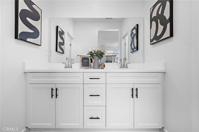 944 N Divino Privado Unit 57, Ontario, CA 91764 - full bathroom with double vanity and baseboards