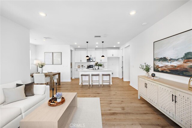 944 N Divino Privado Unit 57, Ontario, CA 91764 - living area with recessed lighting and light wood-style flooring