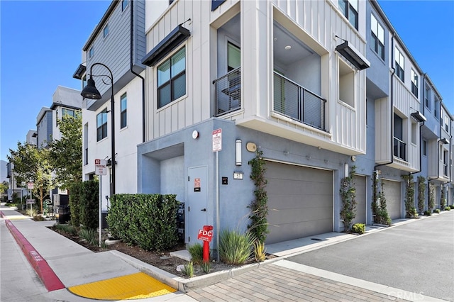 944 N Divino Privado Unit 57, Ontario, CA 91764 - view of property with a garage and a residential view