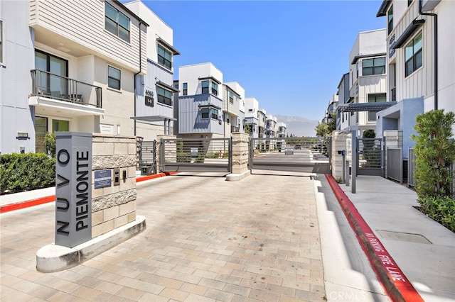 944 N Divino Privado Unit 57, Ontario, CA 91764 - view of decorative street with a residential view, curbs, and a gated entry
