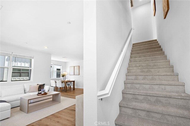 944 N Divino Privado Unit 57, Ontario, CA 91764 - stairway with wood finished floors