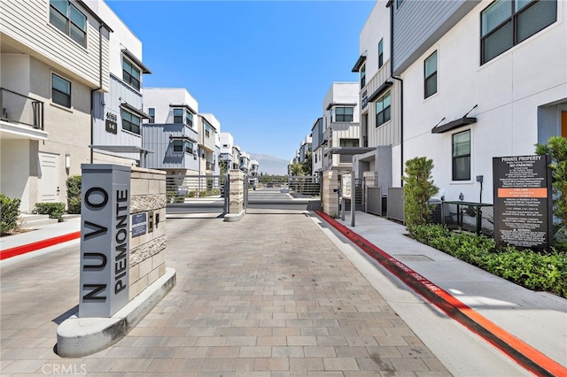 944 N Divino Privado Unit 57, Ontario, CA 91764 - view of road with a residential view, sidewalks, curbs, and a gated entry