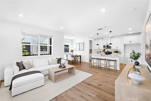 944 N Divino Privado Unit 57, Ontario, CA 91764 - living area featuring recessed lighting and light wood-style floors