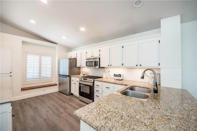 783 Pointe Vista Ln, Corona, CA 92881 - kitchen featuring appliances with stainless steel finishes, white cabinetry, vaulted ceiling, light stone counters, and wood finished floors