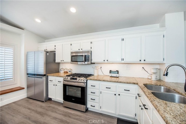 783 Pointe Vista Ln, Corona, CA 92881 - kitchen featuring stainless steel appliances, white cabinets, decorative backsplash, light stone counters, and light wood-style flooring
