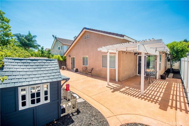 783 Pointe Vista Ln, Corona, CA 92881 - back of property featuring a pergola, a fenced backyard, a patio, and stucco siding
