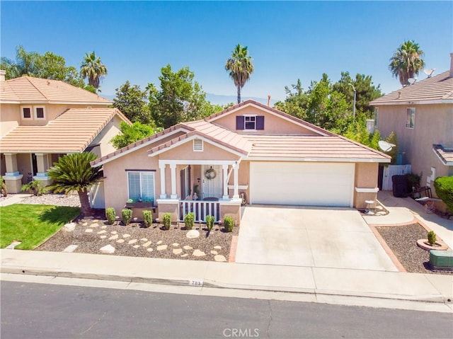 783 Pointe Vista Ln, Corona, CA 92881 - view of front facade with concrete driveway, a porch, a garage, stucco siding, and a tiled roof
