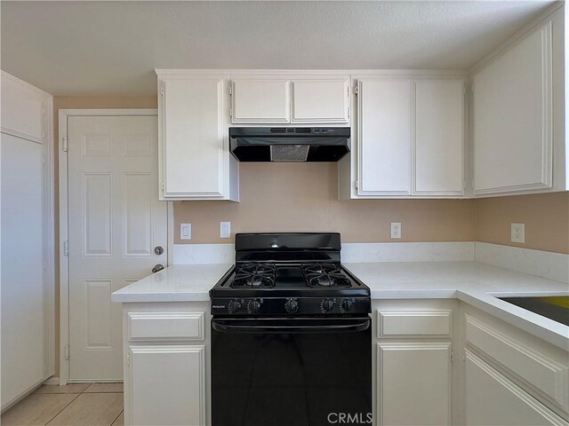22241 Cholena Rd, Apple Valley, CA 92307 - kitchen featuring extractor fan, black gas range oven, light countertops, white cabinets, and light tile patterned flooring
