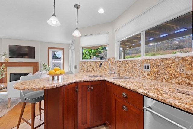 9481 Deanly St, Lakeside, CA 92040 - kitchen with dishwasher, light stone countertops, backsplash, decorative light fixtures, and a breakfast bar area