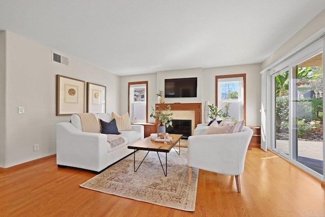 9481 Deanly St, Lakeside, CA 92040 - living area with wood finished floors and a glass covered fireplace