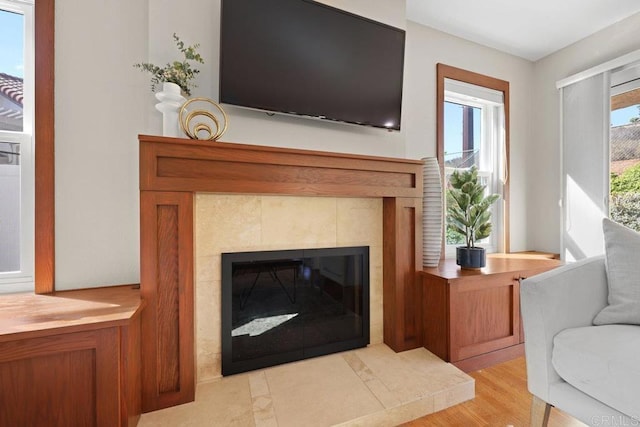 9481 Deanly St, Lakeside, CA 92040 - living area with a tile fireplace and light wood-style flooring