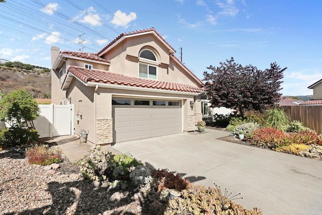 9481 Deanly St, Lakeside, CA 92040 - mediterranean / spanish-style home with driveway, a tiled roof, stucco siding, and stone siding