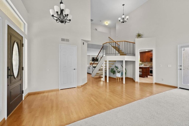 9481 Deanly St, Lakeside, CA 92040 - foyer entrance featuring a chandelier, a towering ceiling, stairs, and wood finished floors