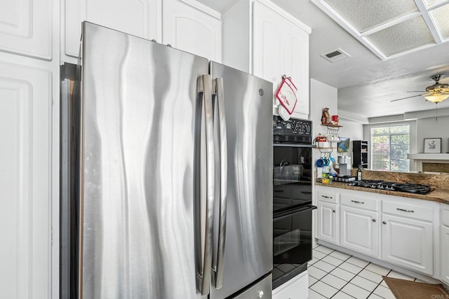 3428 Cameo Dr # 49, Oceanside, CA 92056 - kitchen featuring freestanding refrigerator, gas stovetop, white cabinetry, light tile patterned floors, and ceiling fan