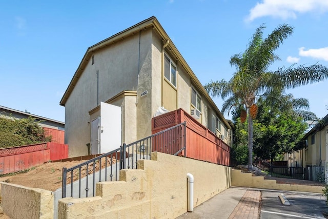 4402 Delta St Unit 23, San Diego, CA 92113 - view of side of home with stairway, stucco siding, and cooling unit