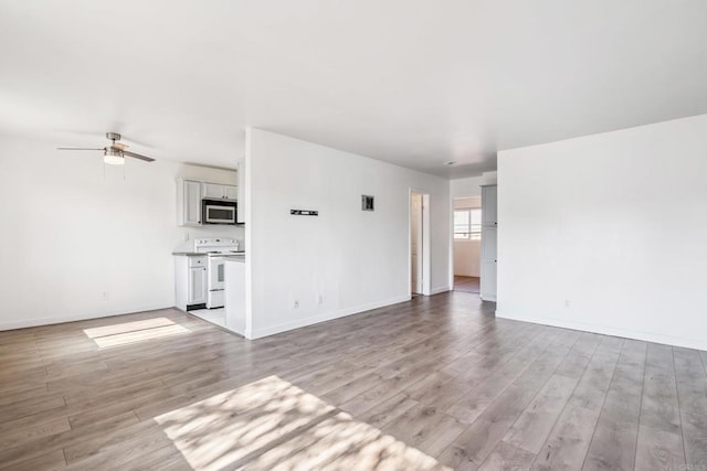 4402 Delta St Unit 23, San Diego, CA 92113 - unfurnished living room featuring light wood-style floors and ceiling fan