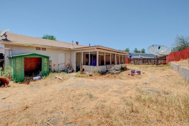 10151 Strathmore Dr, Santee, CA 92071 - rear view of property with a sunroom, a storage unit, and a fenced backyard