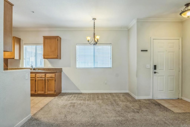 7677 Mission Gorge Rd Unit 148, San Diego, CA 92120 - kitchen with brown cabinetry, a chandelier, light colored carpet, crown molding, and hanging light fixtures