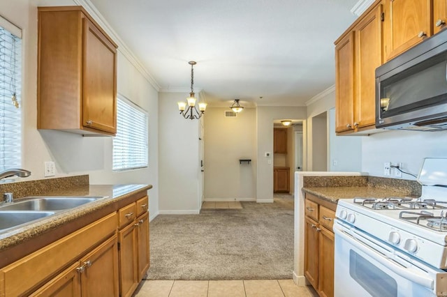7677 Mission Gorge Rd Unit 148, San Diego, CA 92120 - kitchen featuring white gas stove, stainless steel microwave, light carpet, ornamental molding, and brown cabinets