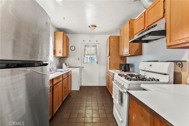 1932 S Orange Ave, West Covina, CA 91790 - kitchen featuring freestanding refrigerator, gas range gas stove, under cabinet range hood, light countertops, and washer / dryer