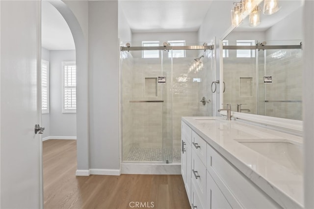 41 Breakers Ln, Aliso Viejo, CA 92656 - bathroom featuring wood finished floors, a stall shower, and double vanity