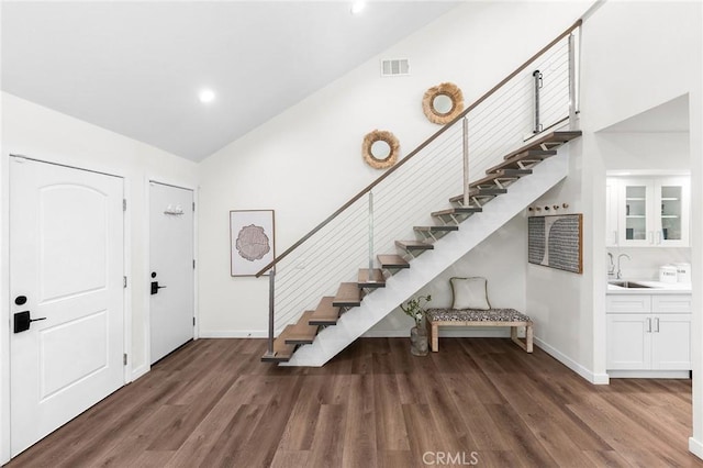 11685 Lakia Dr, Cypress, CA 90630 - foyer entrance featuring stairway, wood finished floors, high vaulted ceiling, and recessed lighting
