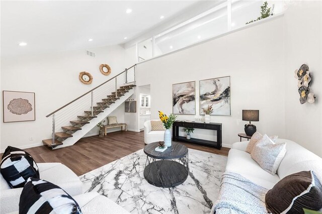 11685 Lakia Dr, Cypress, CA 90630 - living area featuring stairs, wood finished floors, recessed lighting, and high vaulted ceiling