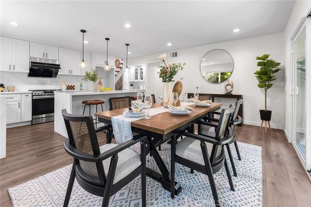 11685 Lakia Dr, Cypress, CA 90630 - dining room with wood finished floors, recessed lighting, and stairway