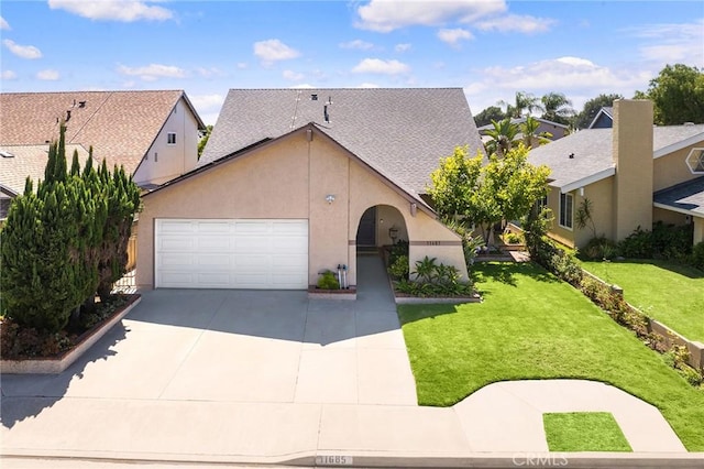 11685 Lakia Dr, Cypress, CA 90630 - view of front of home featuring an attached garage, driveway, stucco siding, a front lawn, and a residential view