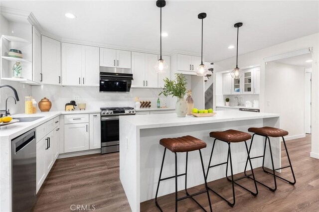 11685 Lakia Dr, Cypress, CA 90630 - kitchen featuring appliances with stainless steel finishes, open shelves, backsplash, white cabinetry, and recessed lighting