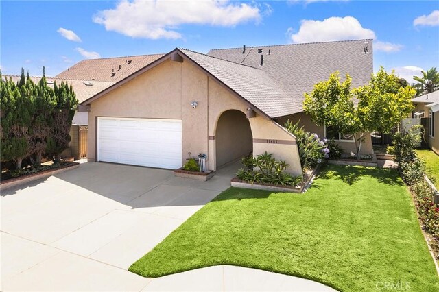 11685 Lakia Dr, Cypress, CA 90630 - view of front of house featuring stucco siding, a garage, driveway, and roof with shingles