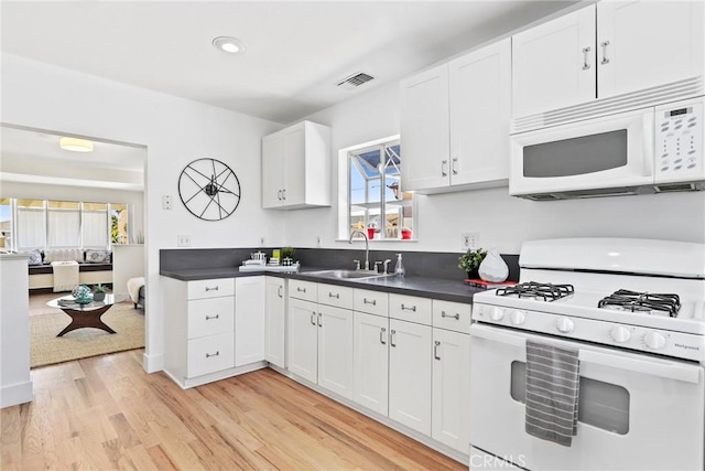 1742 253rd St, Lomita, CA 90717 - kitchen with white appliances, dark countertops, light wood-style floors, white cabinets, and recessed lighting
